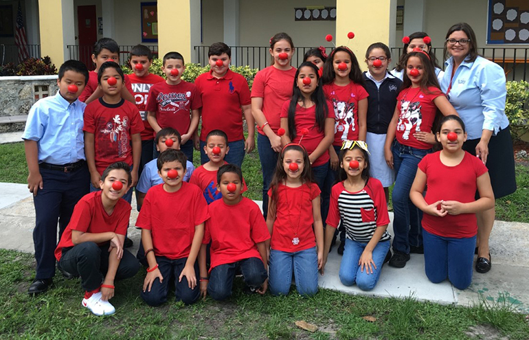 St. Michael's fourth grade class and their teacher, Ivonne Aira, show off their noses.