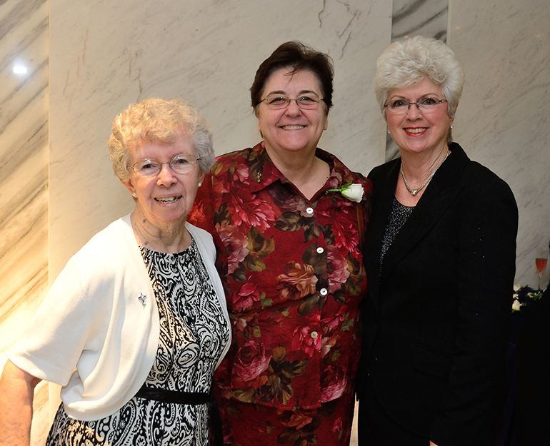 Jan Moran, far right, poses with Sisters Marilyn Canning, far left, and Sister Rita Levasseur of the Sisters of Mercy who have staffed Holy Cross since its founding.