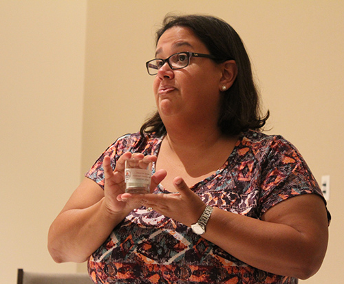 Monica Lauzurique, mission coordinator at Amor en Accion, explains the significance of the candles that are labeled with each day of the mission trip.