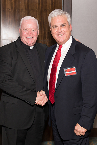 Father Patrick Naughton, parochial vicar at St. Gregory the Great Church in Plantation, poses with attorney W. Anthony "Tony" Loe, a prosecutor for the Broward County State Attorney's Office, who was honored at the 27th annual Red Mass and dinner for the St. Thomas More Society of South Florida.