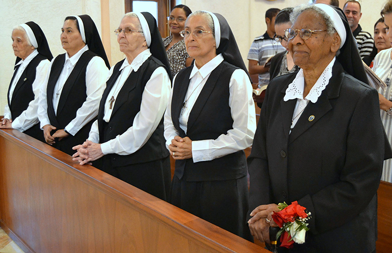 Sister Clementina Givens, right, joins other Oblate Sisters at her farewell Mass.