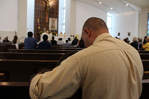 A father consoles his daughter as they mourn the loss of one of their loved one.