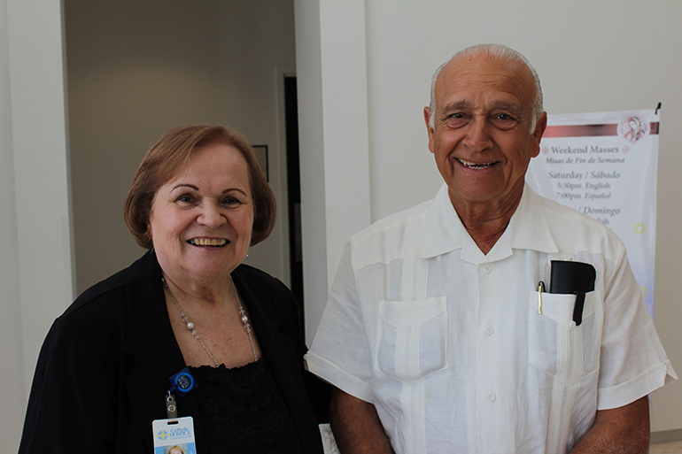 Luz Suarez Macias, bereavement coordinator at Catholic Hospice, stands alongside Alfredo Jacomino, who lost his wife in December after 48 years of marriage.