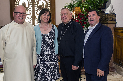 Father Michael Davis, Little Flower's pastor, poses for a photo with Janet Graffius, collections curator at Stonyhurst College, England, Archbishop Thomas Wenski and Stephen Colella, cabinet secretary of Parish Life in the archdiocese.