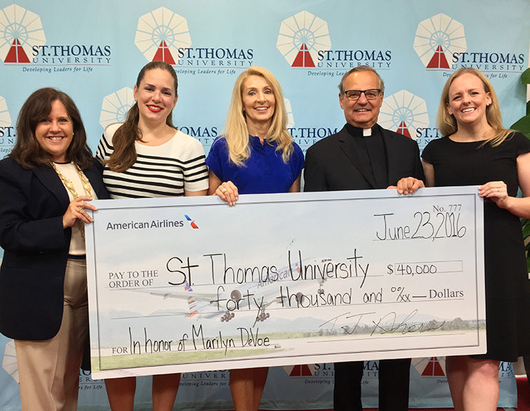 Receiving the AA gift to St. Thomas University, from left: Hilda Fernandez, vice president of the office of advancement; Alexis Aran Coello, AA corporate communications manager - Miami; Marilyn DeVoe, AA vice president - Miami; Msgr. Franklyn Casale, STU president; and Griffin Gonzalez, AA community relations manager - Dallas.