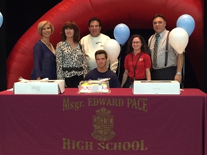 Msgr. Edward Pace High School tennis star Josvany Lesende poses for a photo with his family, coaches, and Pace Principal Ana Garcia (first on left) after signing a letter of intent to play tennis for St. Thomas University.