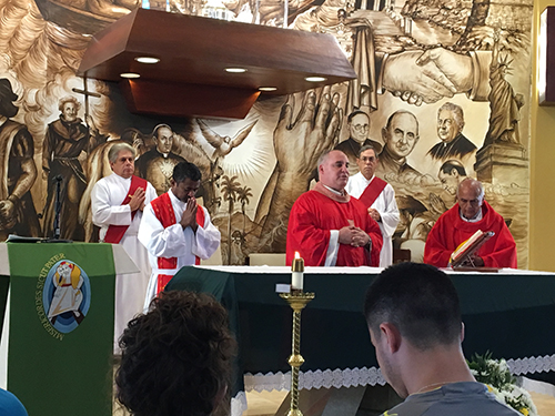 Participants in SEPI's Immersion in Spanish Language and Culture program celebrate Mass with Father Juan Rumin Dominguez, center, rector at the Shrine of Our Lady of Charity in Miami.