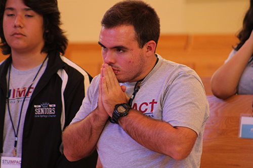 Participants of STU Impact pray during the closing Mass of the theology summer institute.