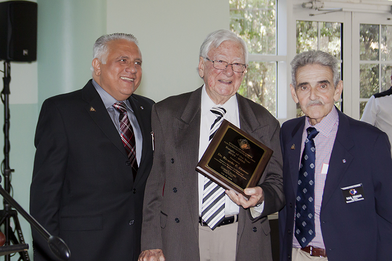 Dr. Ricardo F. Alonso receives the Knight of the Year award at the Knights of Columbus Council 13654 annual banquet.  At left is the council's outgoing Grand Knight Gustavo T. Navarro, and at right is District Deputy Raul Cendan.