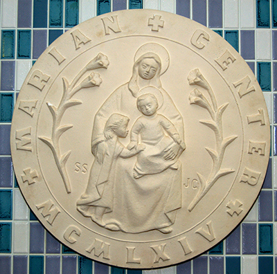Logo of the Marian Center shows Mary embracing the baby Jesus on her lap, along with a child standing beside her, who represents all the children the center cares for. The logo was adapted from an artwork, "La Madonna del Silenzio," that the center's founder, the late Sister Lucia Ceccotti, brought from Italy in 1963.