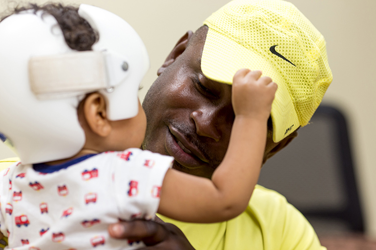 Theron Brown, a father and client of Project Joseph, talks with program staff and volunteers.