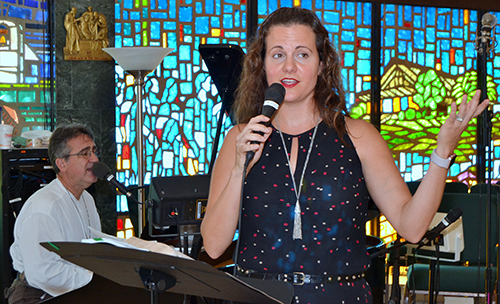 Kristen R. Noffsinger leads music at St. Pius X, with Andrew Reid on piano.