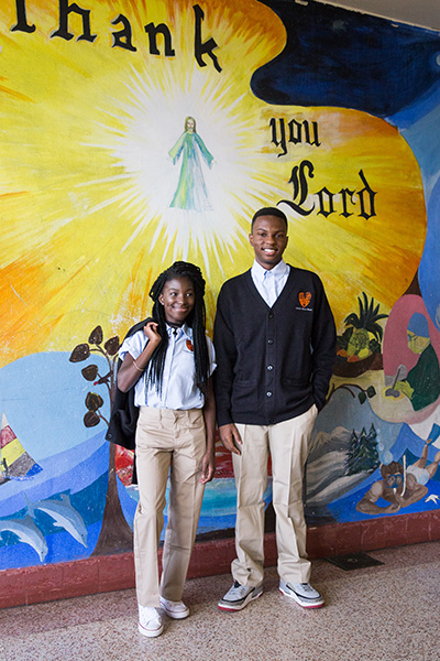 Tontyana Francoeurk and Michael Petit-Homme sport new clothes during an Aug. 16 distribution of donated school uniforms at Archbishop Curley Notre Dame Prep in Miami.