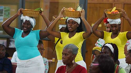 Young girls dressed take up the offertory  in traditional Haitian style the feast day Mass at St. Helen Church, Lauderdale Lakes.
