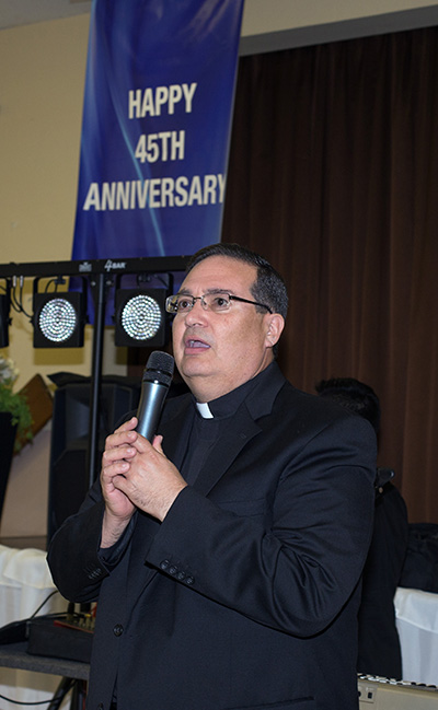 Father Carlos Vega, St. Bernard's pastor, says the blessing before banquet.