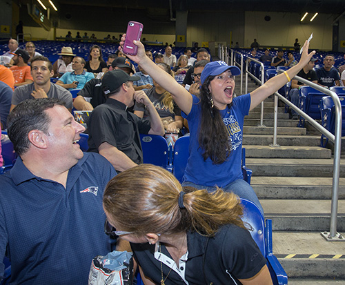 Estrella Cordero from St. Augustine Church and Catholic Student Center roots for the Kansas City Royals, despite her fellow young adults' playful objections. She recently moved from Kansas City to Miami.
