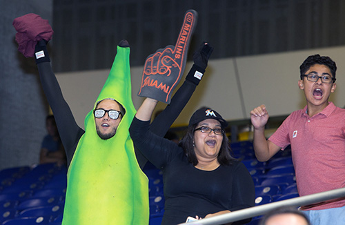 Young adult Marie Curtis, from Good Shepherd Church, center, roots for the Marlins along with "Plantain Man."