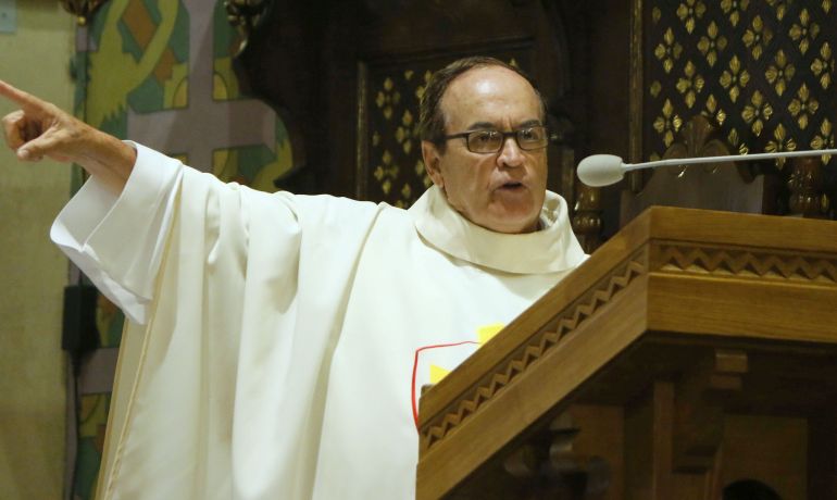 Father Silverio Rueda, now recovered from his return trek from the papal Mass the day before, points out some of the artistic details of the church in Zakopane.