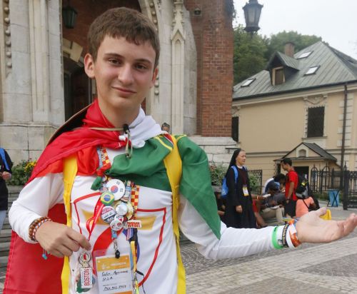 Colin Apruzzese, 17, shows off some of the bracelets, pins, flags and other items he has acquired during World Youth Day. He will be a senior this fall at St. Thomas Aquinas High School in Fort Lauderdale.