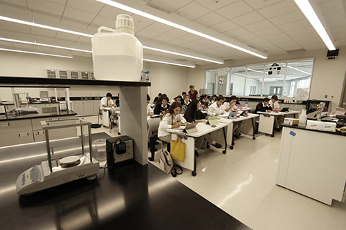 Students learn at their desks before doing hands-on work in a lab located in the same classroom of St. Brendan High School's new Innovation Center.