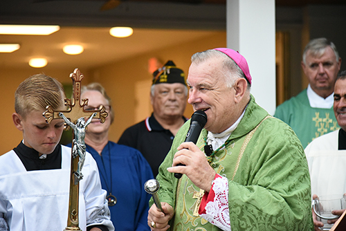 Archbishop Thomas Wenski addresses the congregation before blessing the Klaus Murphy Center. At left is Father John Baker, pastor of the Basilica of St. Mary Star of the Sea in Key West.