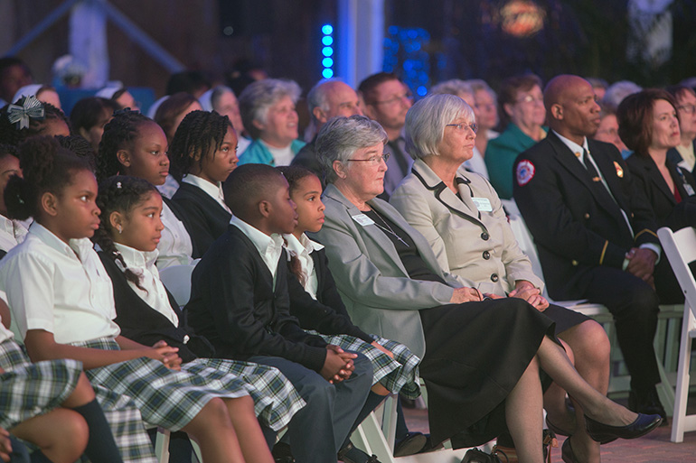 Sister Stephanie Flynn, St. James School principal, and assistant principal Sister Kathleen Carr, watch the documentary along with their students.