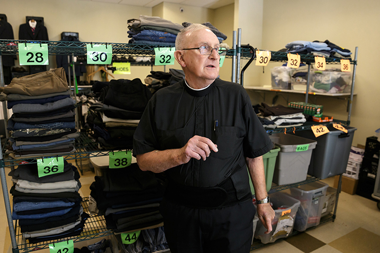 Hospitaller Brother William Osmanski, a direct care ministry provider, runs the clothing donation and distribution room
at Miami's Camillus House.