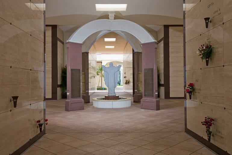 This statue of the Sacred Heart welcomes visitors to the Christ the King mausoleum at Our Lady of Mercy Cemetery in Doral. Catholic Cemeteries of the Archdiocese of Miami embody the words of the new Vatican document by providing a dignified burial place and "a setting which promotes a oneness with God."