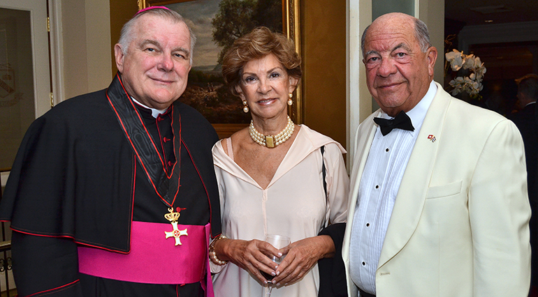 Archbishop Thomas Wenski at the annual White Cross Ball with Sara Maymir and Fernando Capablanca. The latter is director of Cuban projects for the Knights of Malta, including its 62 soup kitchens.