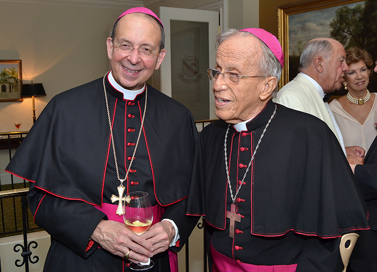 Archbishop William Lori of Baltimore, left, smiles for a photo with retired Auxiliary Bishop Alfred Petit of Havana at the Cuban Knights of Malta annual White Cross Ball.