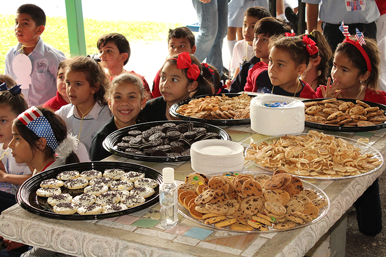 They can't wait for the cookies: Students surround the table of "candidates" as they wait to hear the final results of the cookie elections.