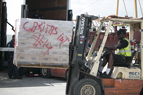Workers with Seacoast Shipping move a pallet of donated items to the Betty K VI, moored on the Miami River Oct. 14, as the first load of emergency relief supplies was loaded for shipping to Miragoane, Haiti.