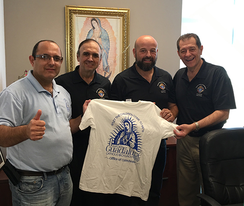 Miguel Ruiz, left, director of religious education at Our Lady of Guadalupe Church in Doral, thanks Knights of Columbus for their donation of 1,000 rosaries. Pictured, from left: Gilbert Lozano, Grand Knight, David Gonzalez, Deputy Grand Knight, and Carlos Sabando, membership director.