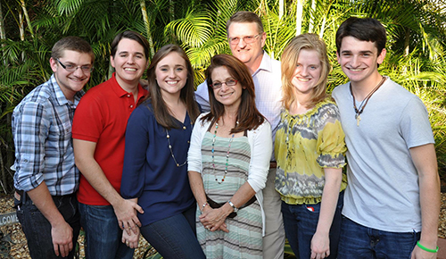 Deacon James Dugard stands behind his family. Pictured, from left: son David, son-in-law Jose Insua, daughter Katherine Insua, wife Nelly, daughter Rachel, and son James.