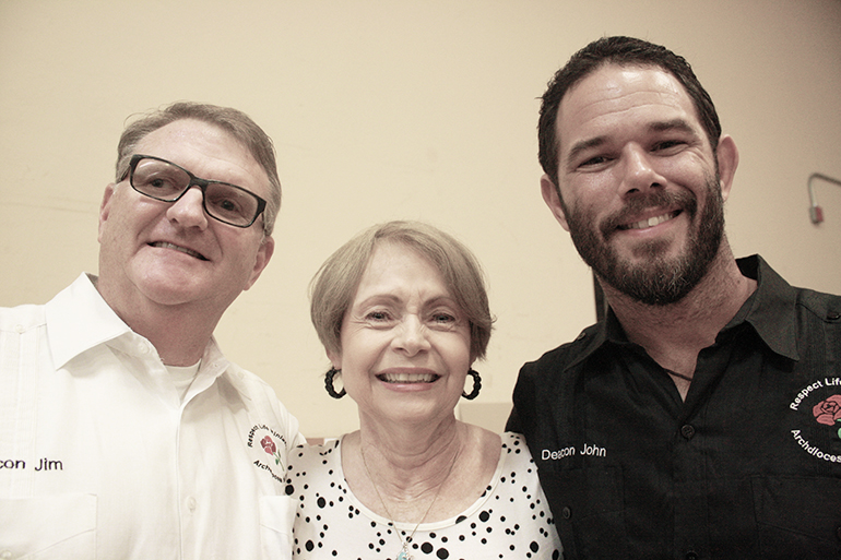 Pro-life “Jedis” Deacon James Dugard, left, and Deacon John Clarke pose with Respect Life Educational Coordinator Barbara Groeber at a Respect Life Awareness Day in August.