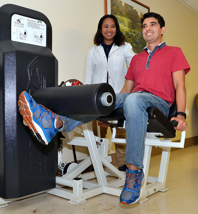 Fernando Pacheco does leg lifts, with oversight by Gemma Longfellow, senior physical therapist at St. Catherine's Rehabilitation Hospital in North Miami.