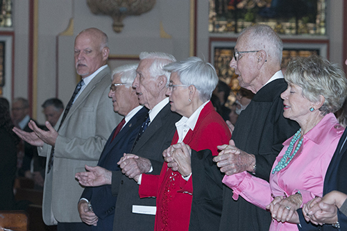 Judge Peter Fay and his wife, Pat, far right, pray the Our Father alongside fellow judges and attorneys during the Oct. 26 Red Mass of the Miami Catholic Lawyers Guild.