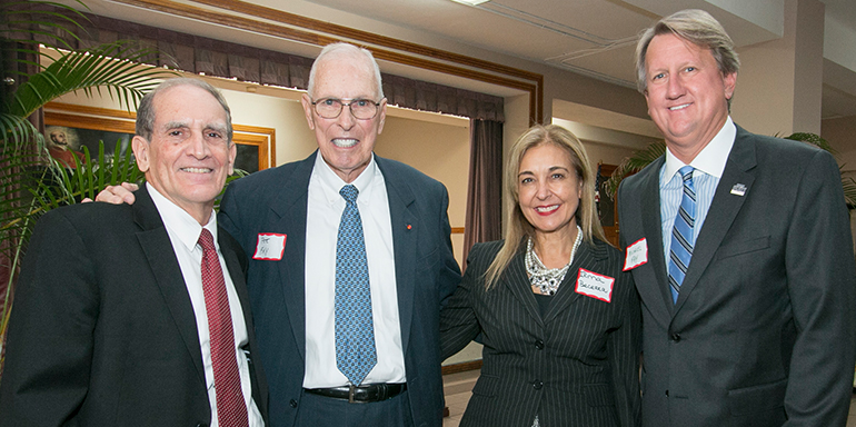 Judge Peter Fay, second from left, poses with St. Thomas University Law School Dean Alfredo Garcia, Provost Irma Becerra, and son Michael Fay. Michael serves on the board of St. Thomas University, and Judge Fay was one of the founders of its law school.