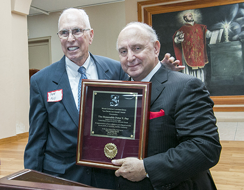 Attorney Herbert Russomanno, right, last year's recipient of the Lex Christi, Lex Amoris award, presents the plaque to this year's recipient, Judge Peter Fay, senior judge of the U.S. Court of Appeals, 11th Circuit. The reception followed the Miami Catholic Lawyers Guild Red Mass at Gesu Church Oct. 26.
