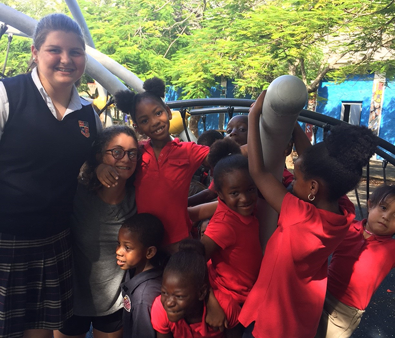 St. Hugh student Solange Aguero plays with the children who attend The Barnyard after-school program in Coconut Grove Village West.