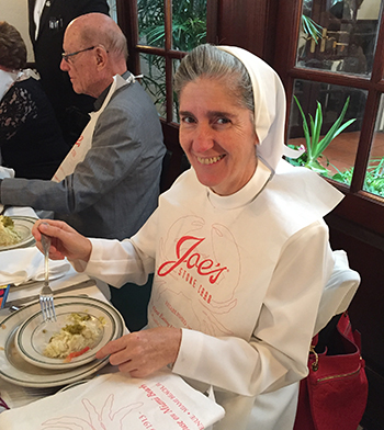 Sister Filomena Mastrangelo, director of Residential Services at the Marian Center, gets ready to dig into her meal at Joe's Stone Crab, Miami Beach. She is one of the Sisters of St. Joseph Benedict Cottolengo who have staffed the Marian Center and School since its foundation more than 50 years ago.
