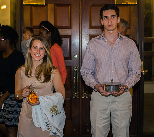 Ashley Mila, an FIU medical student, and Victor Moas, president of the University of Miami chapter of the Catholic Medical Association, bring up the offertory during the White Mass for medical professionals celebrated Nov. 13 at St. Augustine Church and Catholic Student Center in Coral Gables.