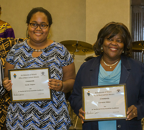 St. Martin de Porres awardees Sarady Amparo, left, and Lavanette Miller pose with their certificates.