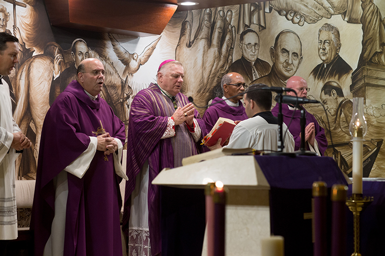 Miami Archbishop Thomas Wenski celebrates Mass Nov. 26 at Our Lady of Charity National Shrine (La Ermita de la Caridad) in Miami with members of the Cuban community, the day after former Cuban leader Fidel Castro died. At left is Father Fernando Heria, rector of the shrine. The archbishop offered prayers for the people of Cuba, invoking the patroness of Cuba, the Virgin of Charity, asking her for peace in Cuba and for its people.