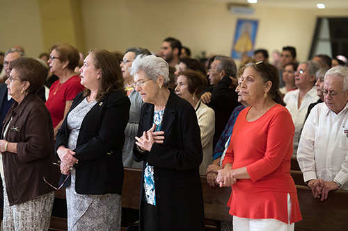 Local Cubans join in prayer during the Mass Miami Archbishop Thomas Wenski celebrated Nov. 26 at Our Lady of Charity National Shrine (La Ermita de la Caridad) in Miami.