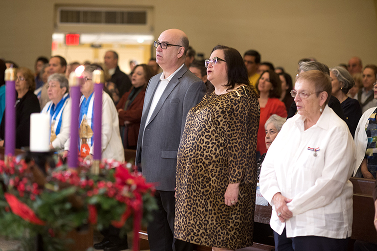Local Cubans, including Emilio Gonzalez, director and CEO of Miami-Dade's Aviation Department, join in prayer during the Mass Miami Archbishop Thomas Wenski celebrated Nov. 26 at Our Lady of Charity National Shrine (La Ermita de la Caridad) in Miami.