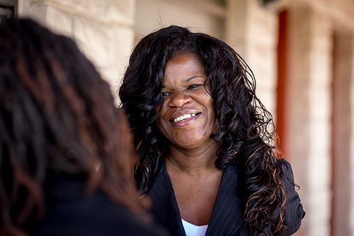 Janet Nichols, regional director of Housing & Homeless Services for Catholic Charities of the Archdiocese of Miami, talks with clients at at New Life Family Center, a Catholic Charities-sponsored motel-style residence providing a safe environment for 15 families while they get back on their feet. Children are the central focus of New Life.