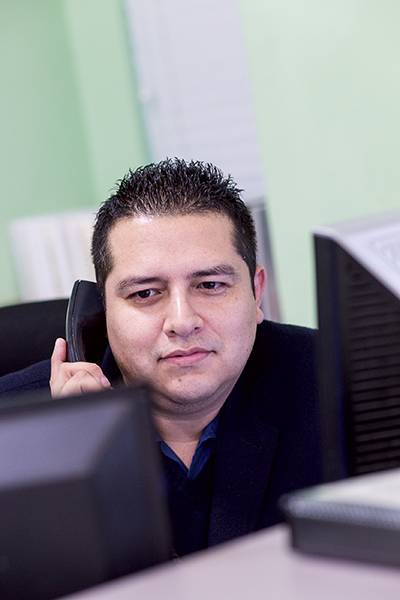 Lannier Alvarez works the front desk at Miami Catholic Charities' St. Luke's Center.