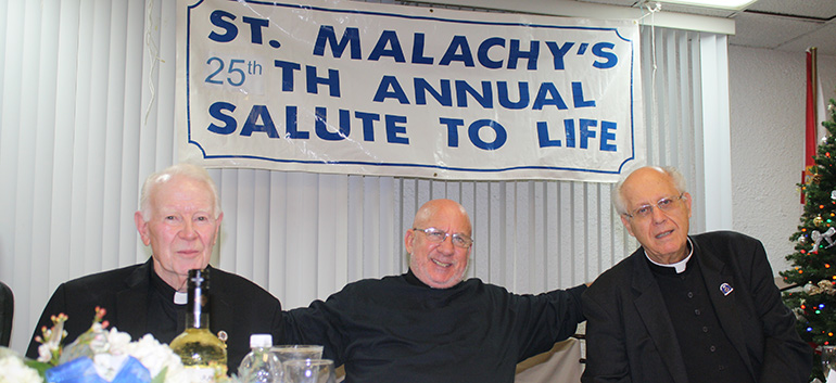 St. Malachy's pastor, Father Dominic O’Dwyer, left, poses with keynote speaker Father Stephen Imbarrato, center, and retired archdiocesan priest, Father John Fink, at the 25th annual Mary for Life Banquet held at St. Malachy Church Dec. 8.