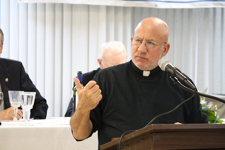 Father Stephen Imbarrato speaks at the 25th annual Mary for Life Banquet held at St. Malachy Church Dec. 8. He shared his story of being complicit in the abortion procured by his former girlfriend and his belief that men are "covert perpetrators" in most abortions.